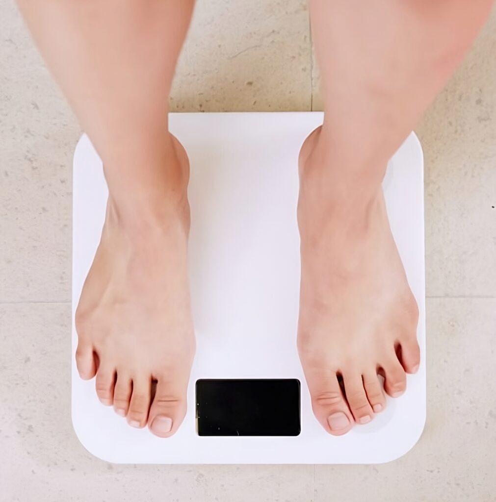 Weight Loss Mistakes. Person on scale in a weight loss program.