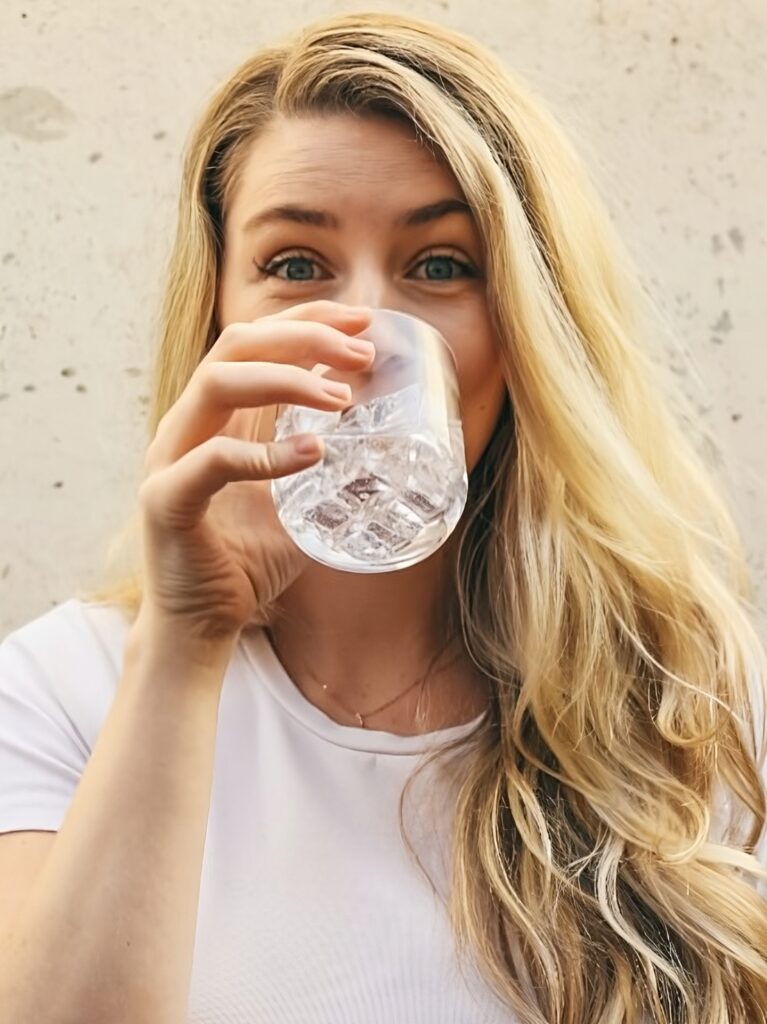 Woman drinking water for a healthy weight loss program.
