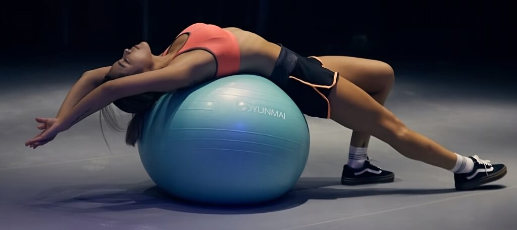 Woman on yoga ball exercising to lose weight.