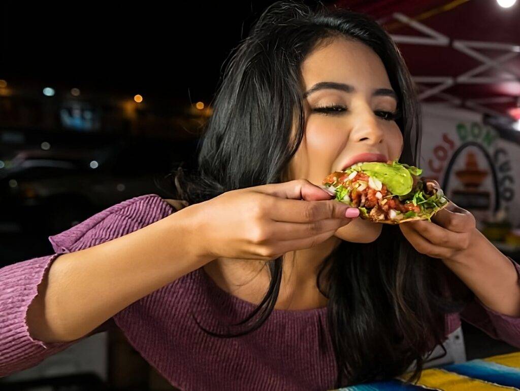 Woman eating healthy tacos.