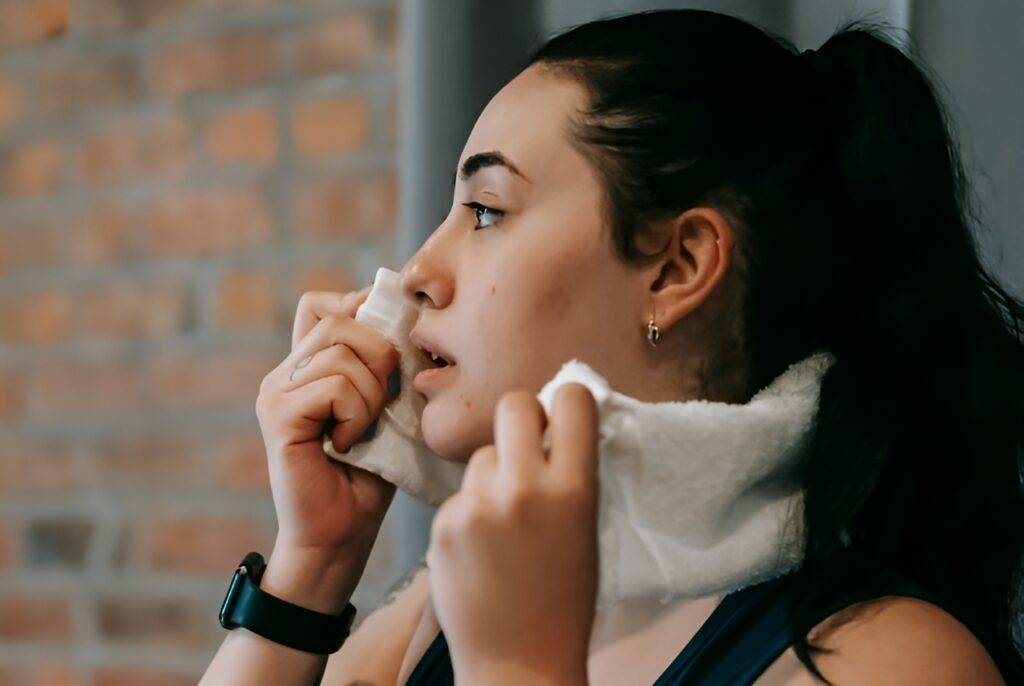 Woman sweating out toxins in exercise gym.